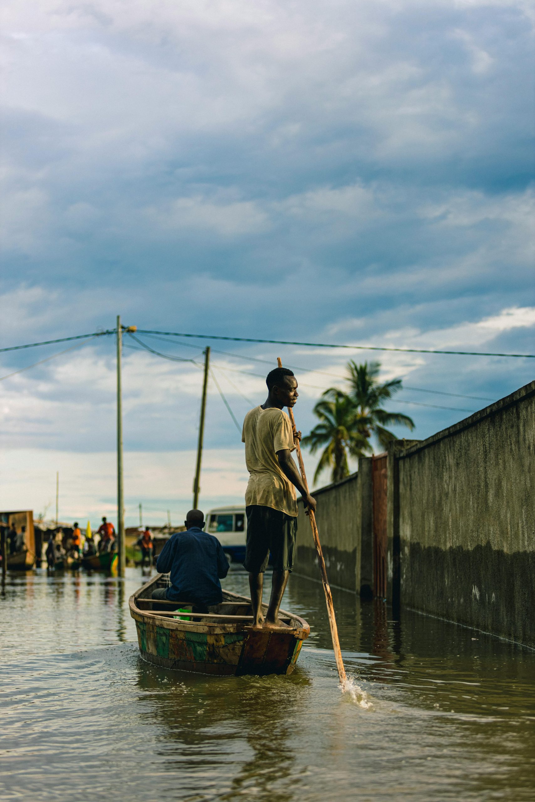 Men on Boat in Village during Flood